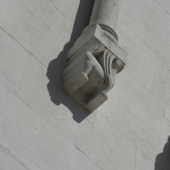 Detailed view of an ornate stone carving on a wall, capturing intricate design elements.